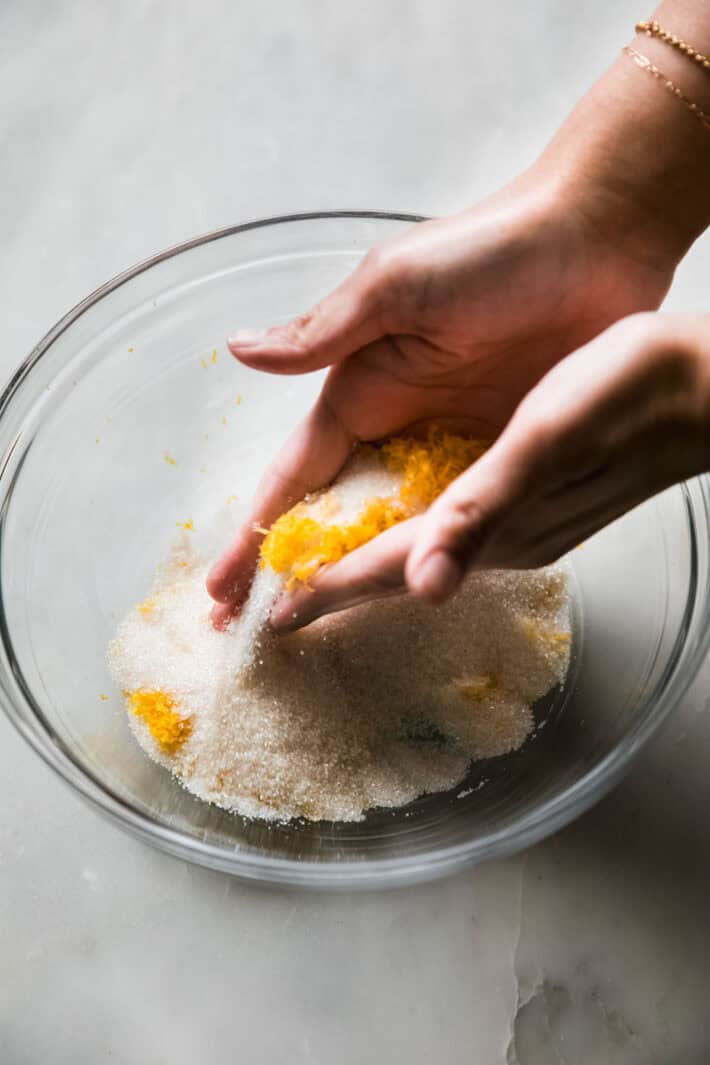 rubbing lemon and sugar together in a bowl