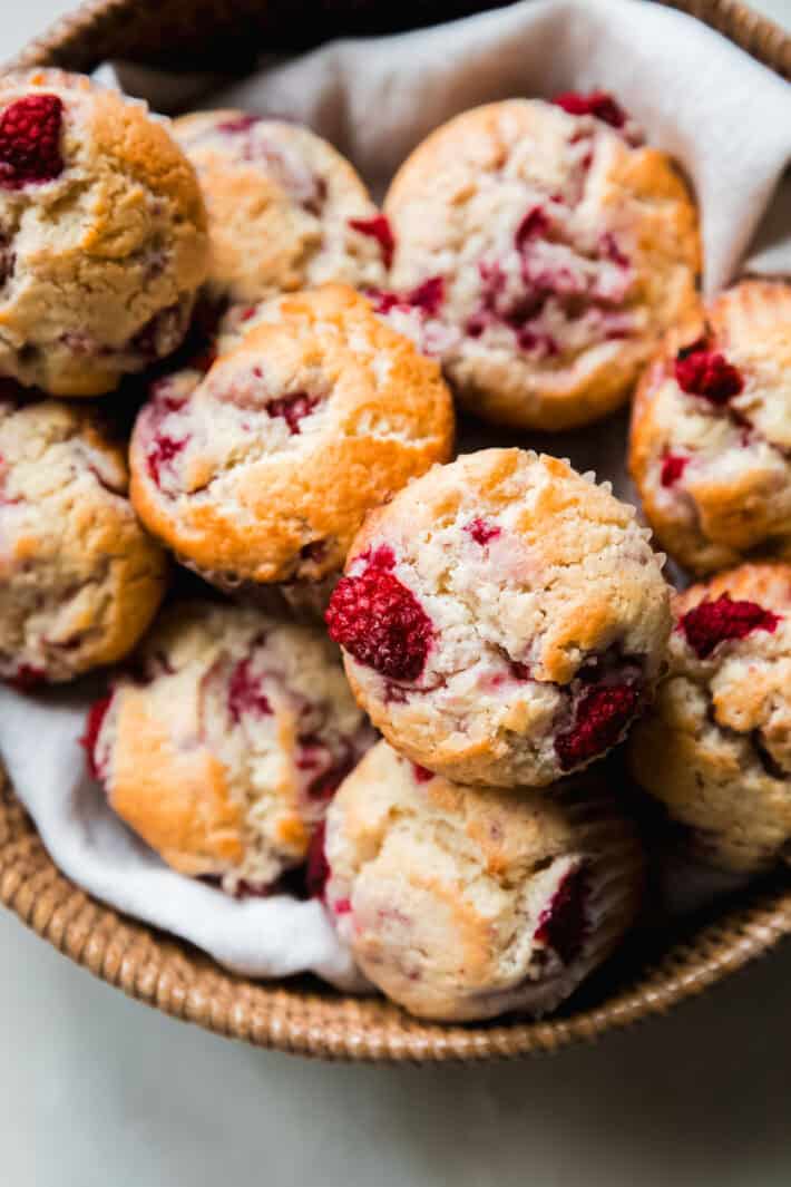 basket of lemon raspberry muffins on white marble