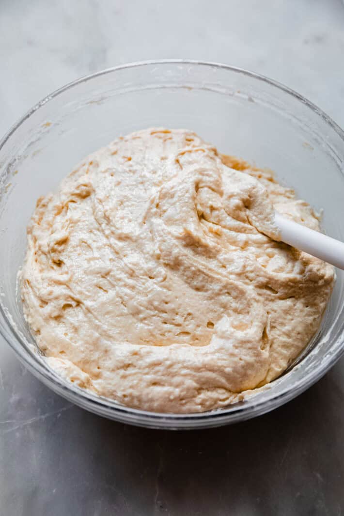 vanilla cake batter in bowl with buttermilk