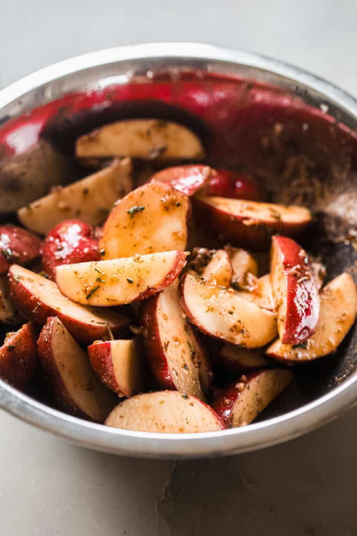 seasoned potatoes in metal bowl