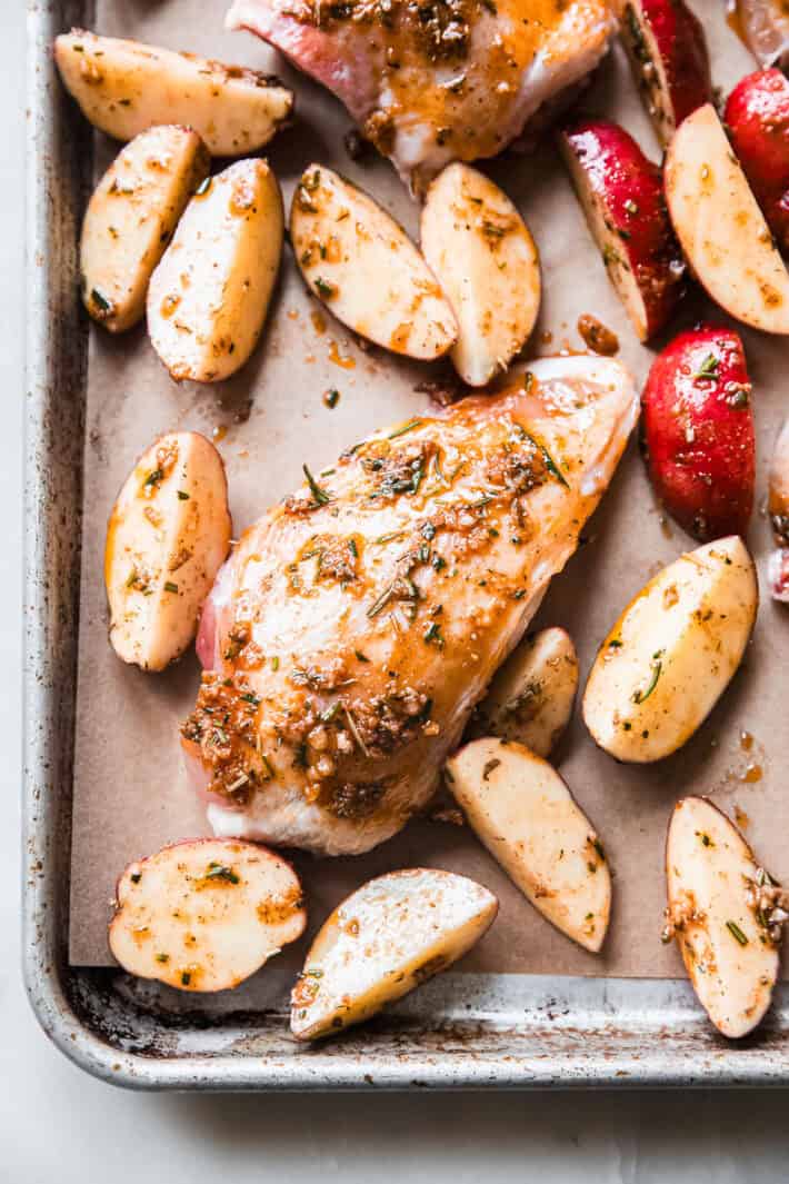 chicken pieces and potatoes before roasting