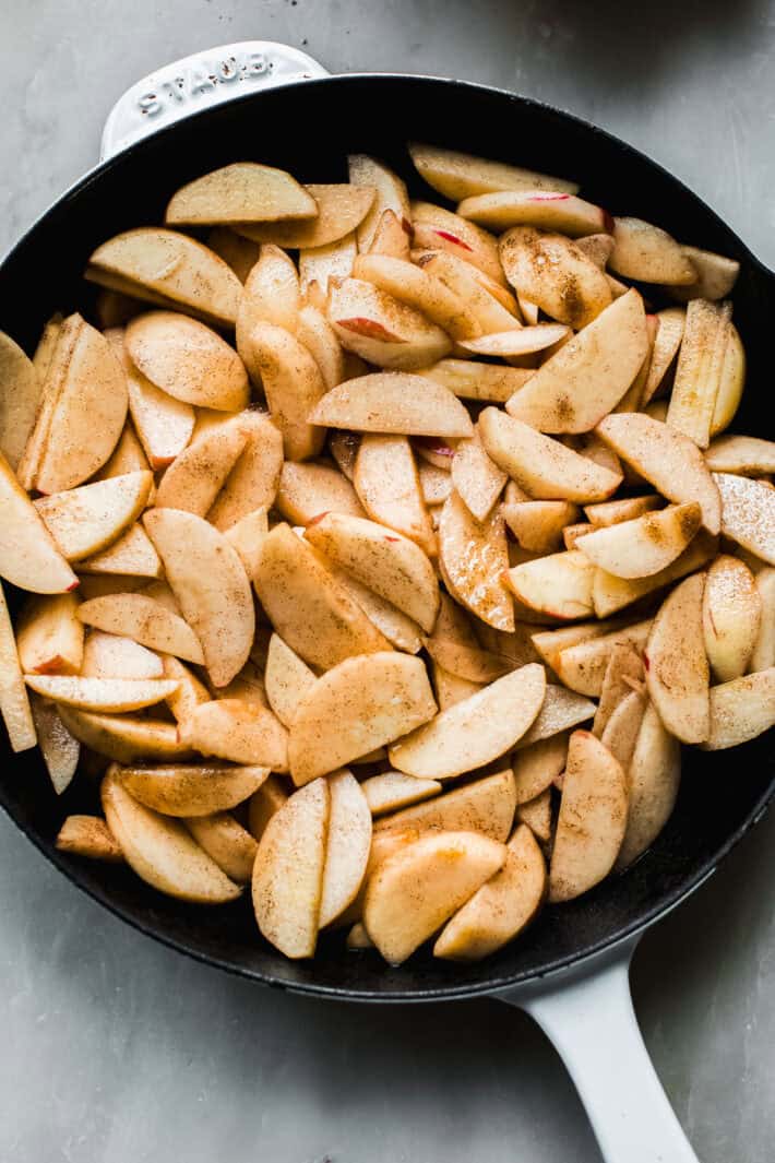 apple crisp apples poured into cast iron pan