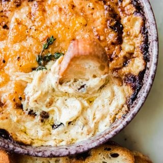 hot caramelized onion dip on marble with crostini