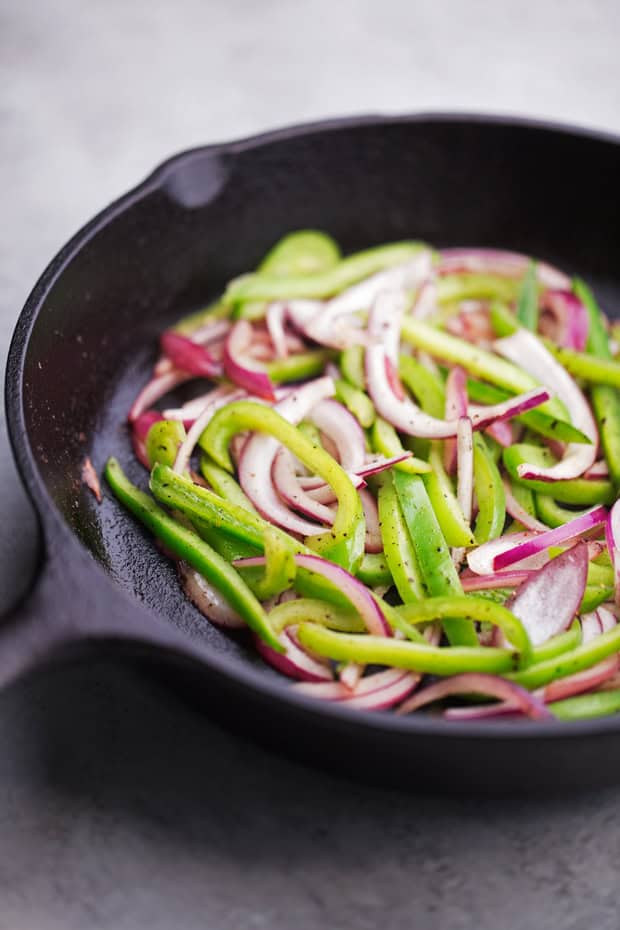 sautéed peppers and onions in skillet