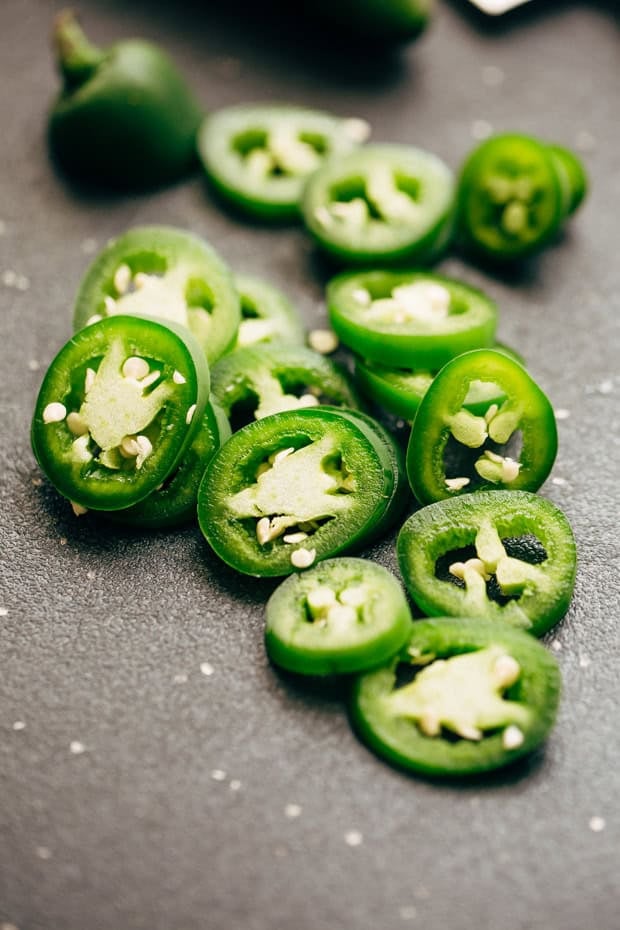 sliced jalapeños on cutting board