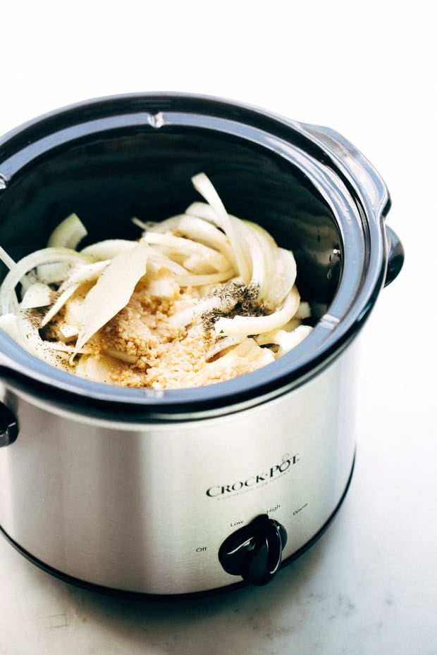 crock pot with French onion pot roast ingredients