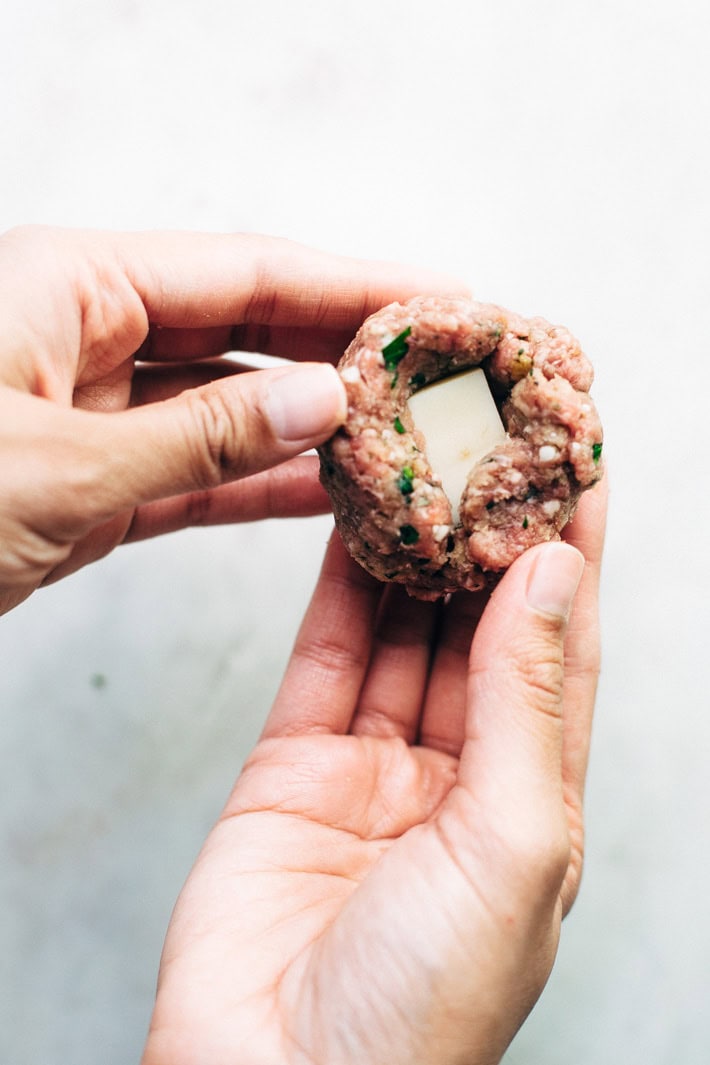 adding cheese to the middle of the meatball