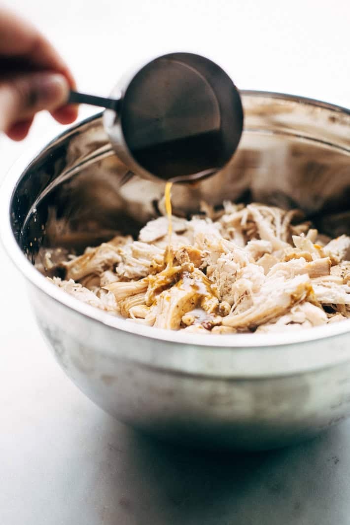 saucing shredded chicken