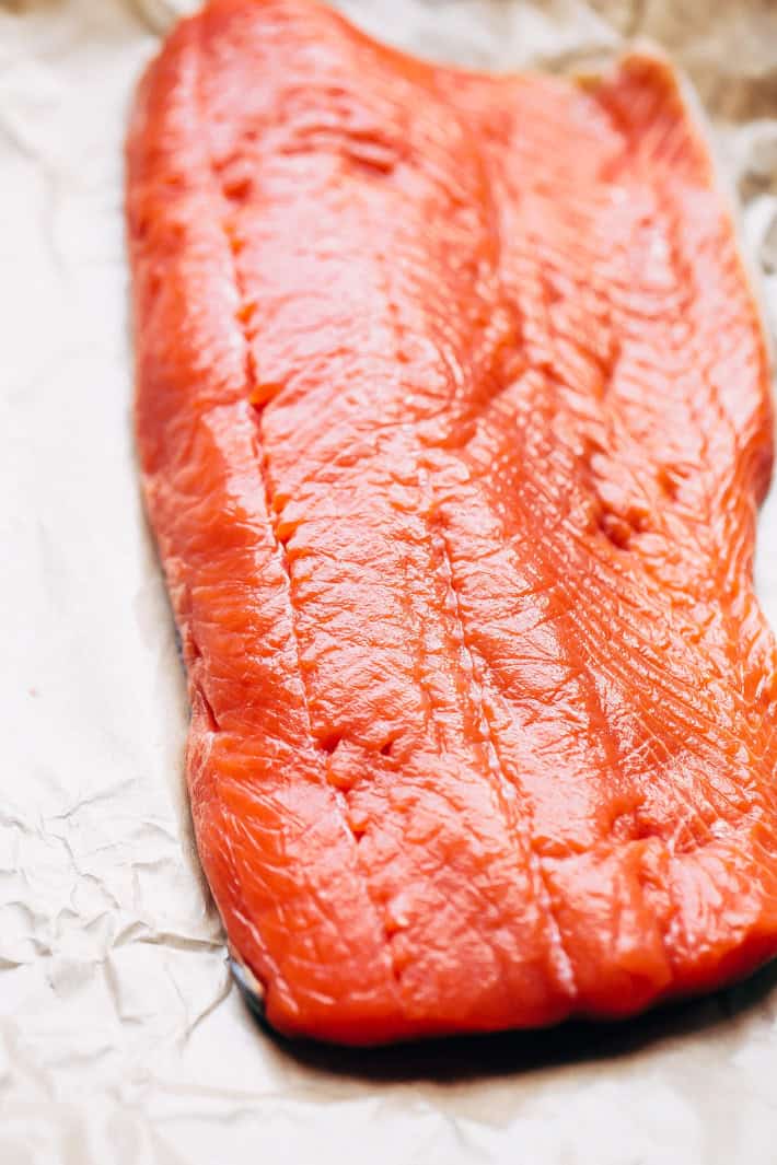 fresh salmon filet on parchment paper