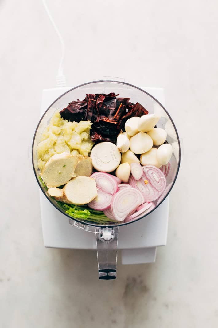 food processor with peppers, garlic, shallots, ginger, etc.