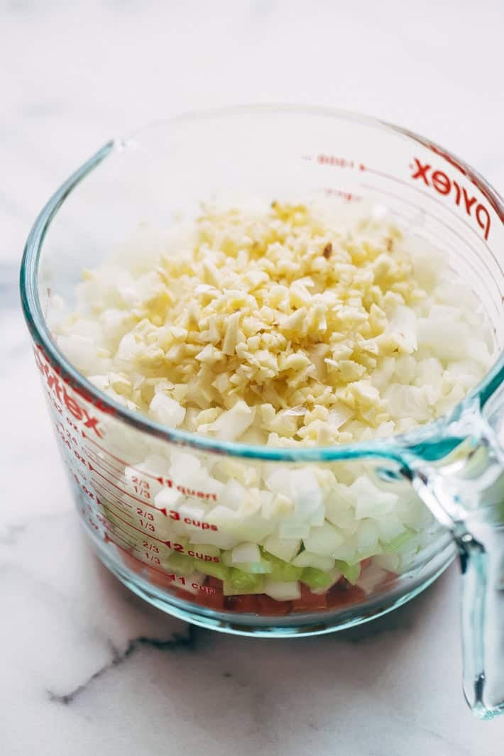 chopped mirepoix and garlic in measuring cup