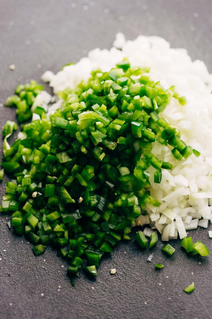 chopped onions and peppers on cutting board