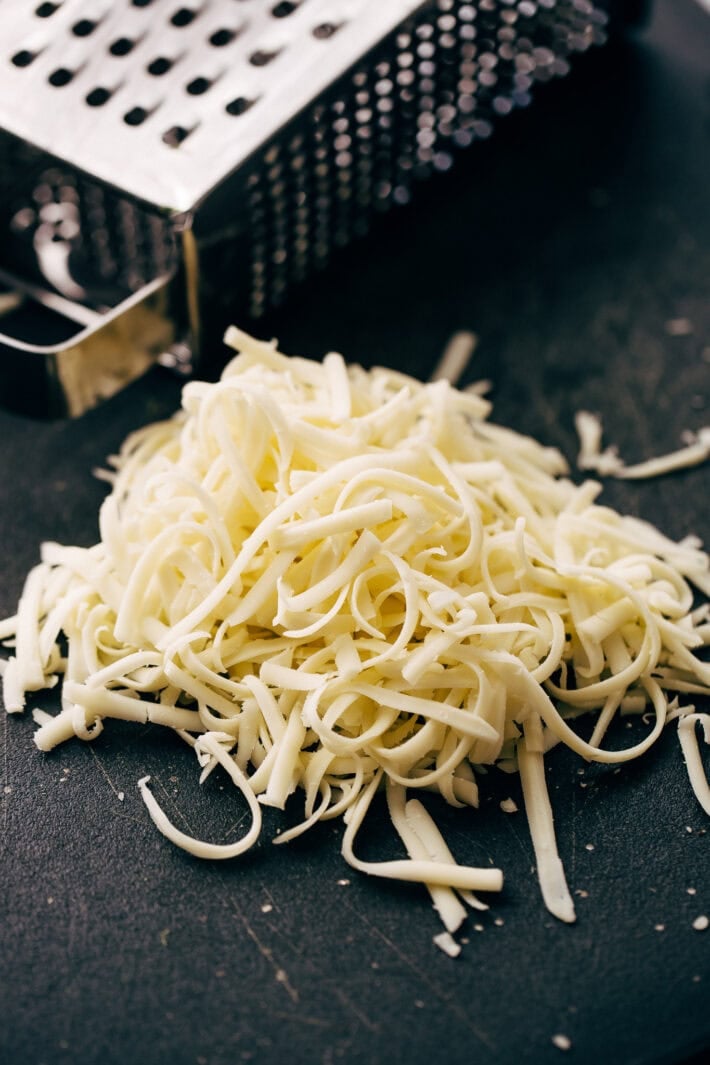grated cheese on cutting board