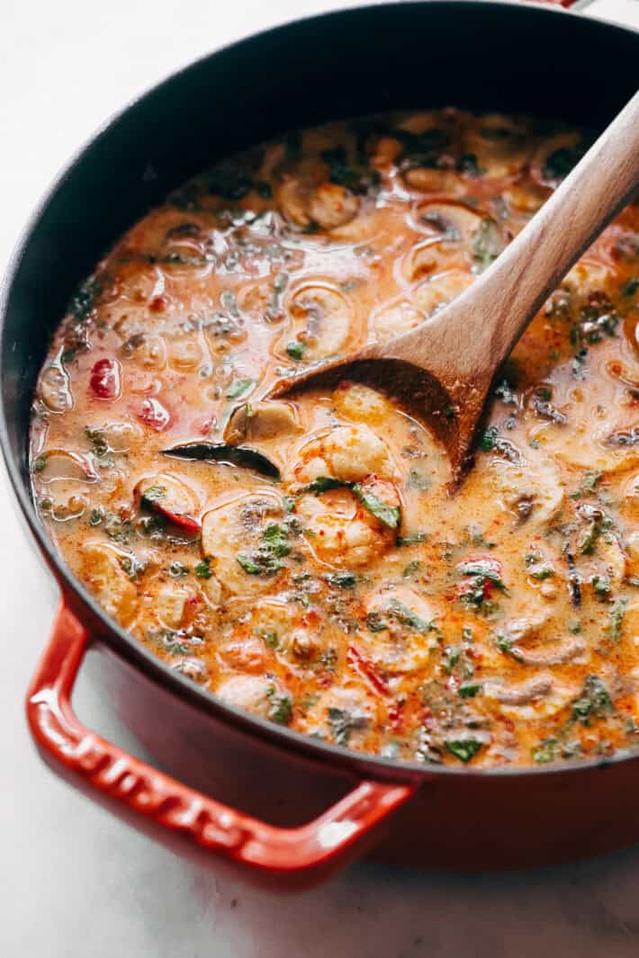 Tom Yum Soup in pot with wooden spoon