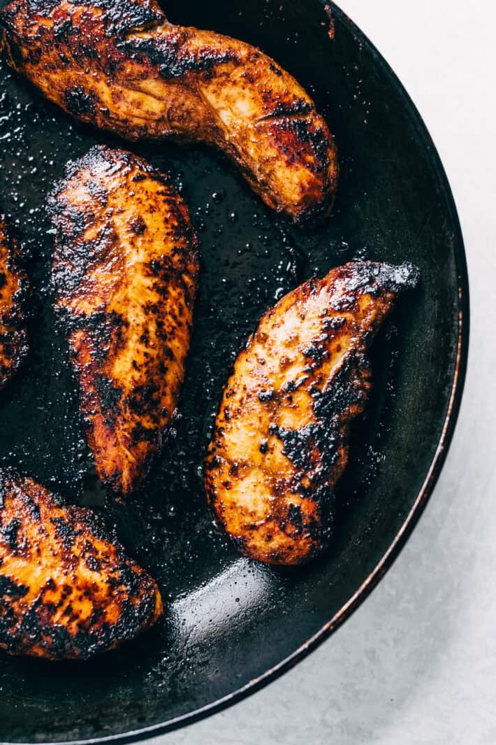 seared chicken tenders in black skillet