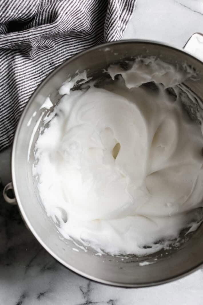 stand mixer bowl with whipped egg whites so they're white and fluffy