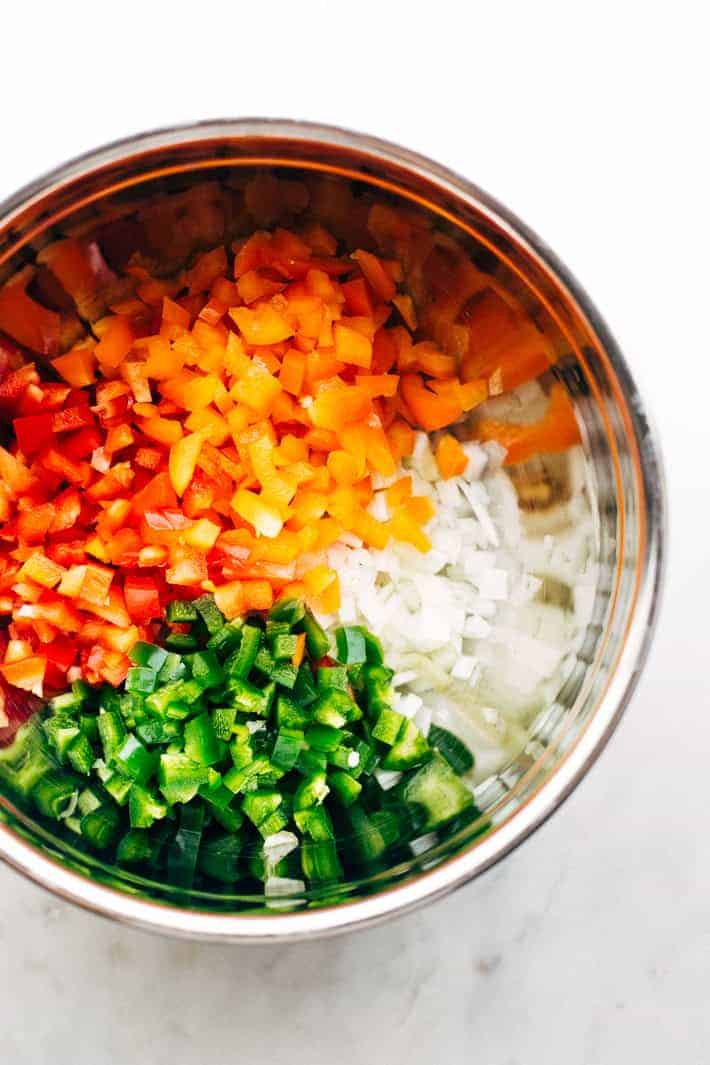 chopped peppers and onions in metal bowl