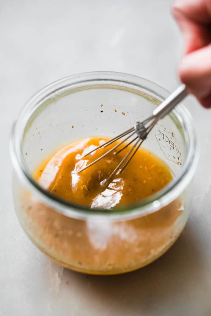 whisking dressing in bowl