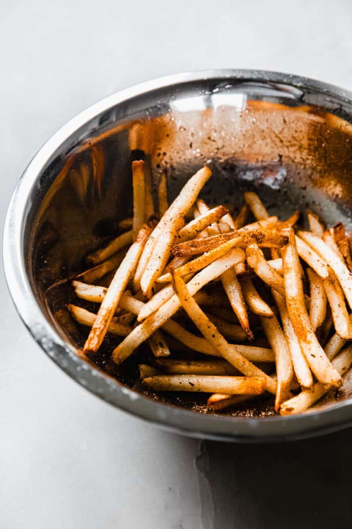 seasoned fries in metal bowl