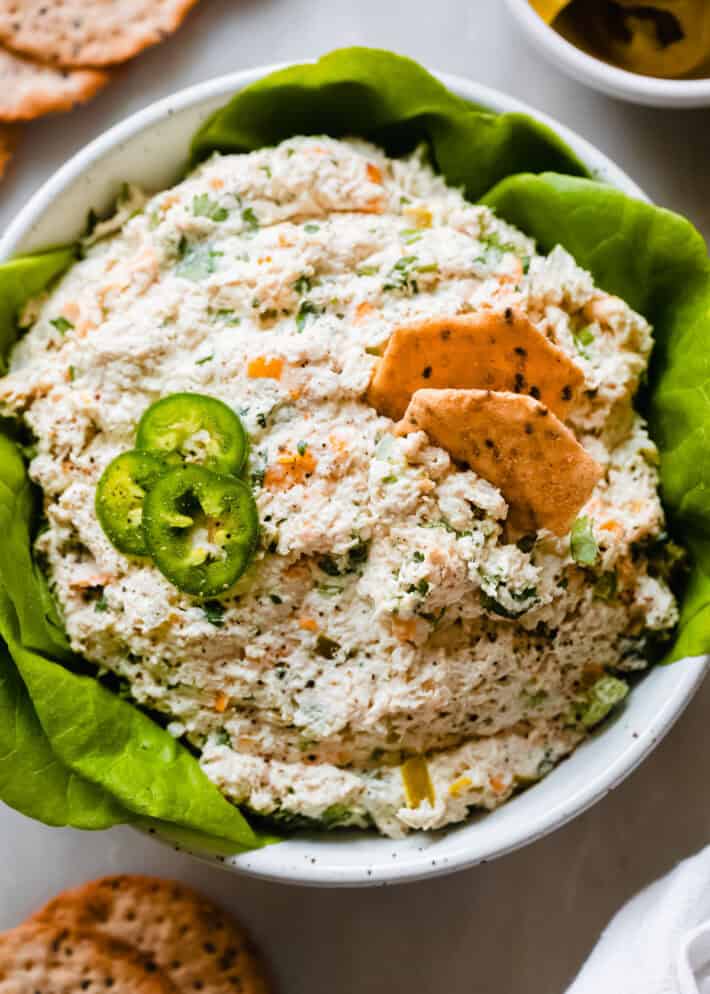 jalapeno chicken salad in bowl with lettuce, jalape&ntilde;o slices and crackers