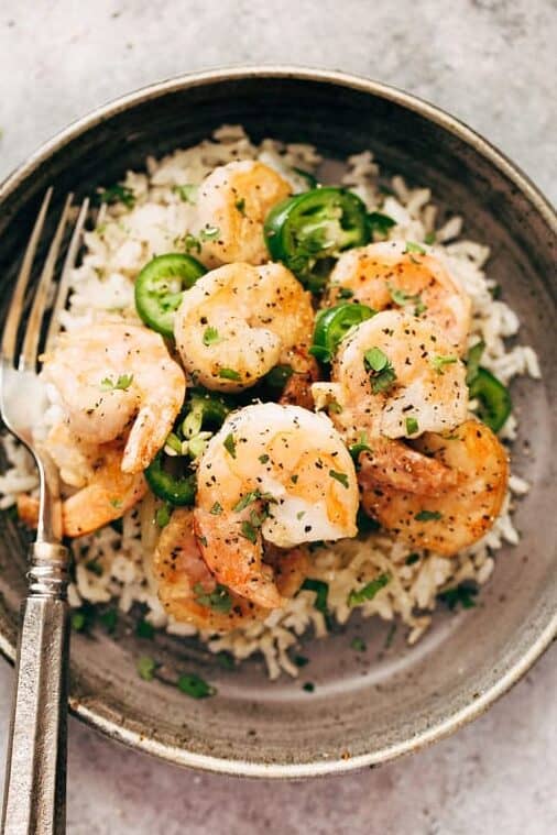 cooked shrimp with salt and pepper in bowl over rice
