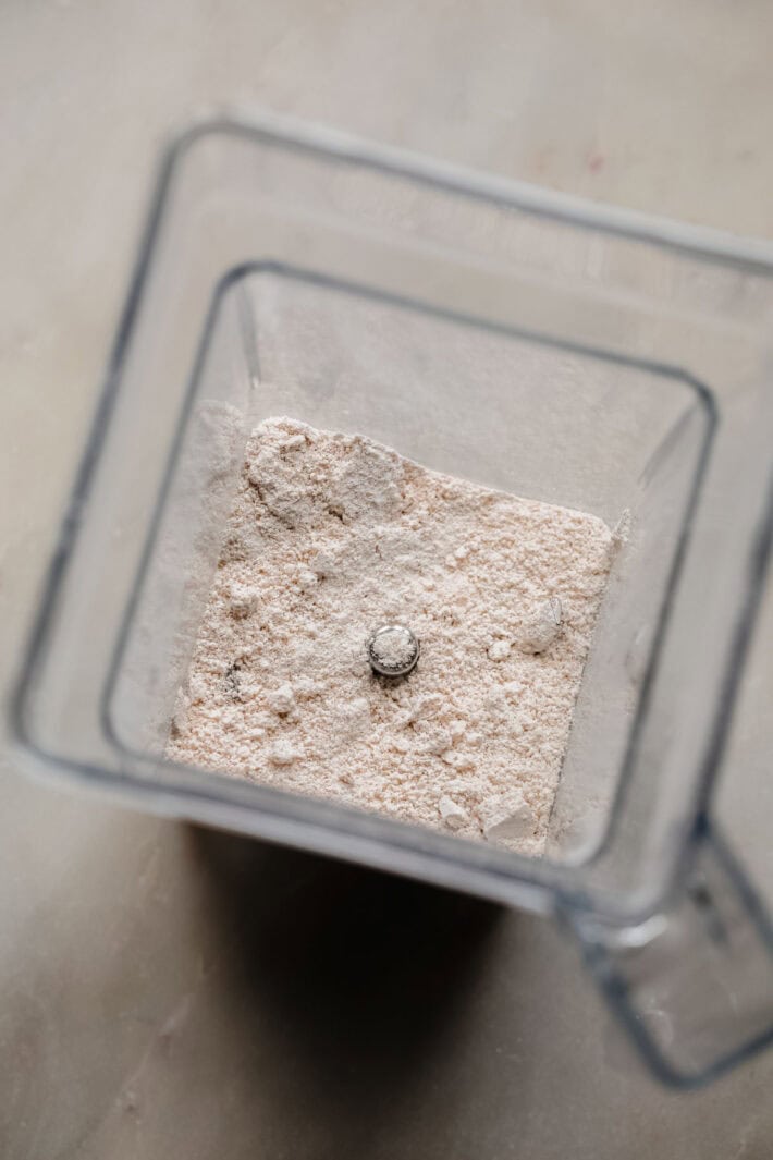 oats blended into oat flour in blender jug