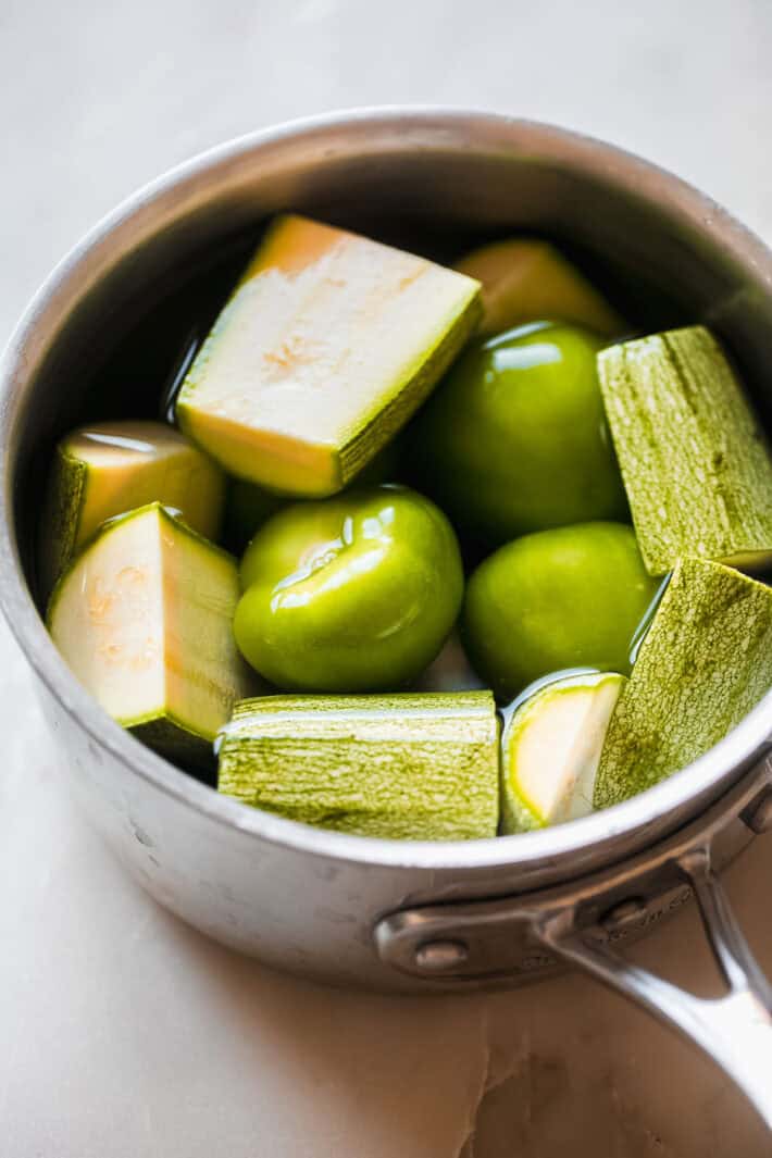 mexican squash and tomatillos in water before boiling