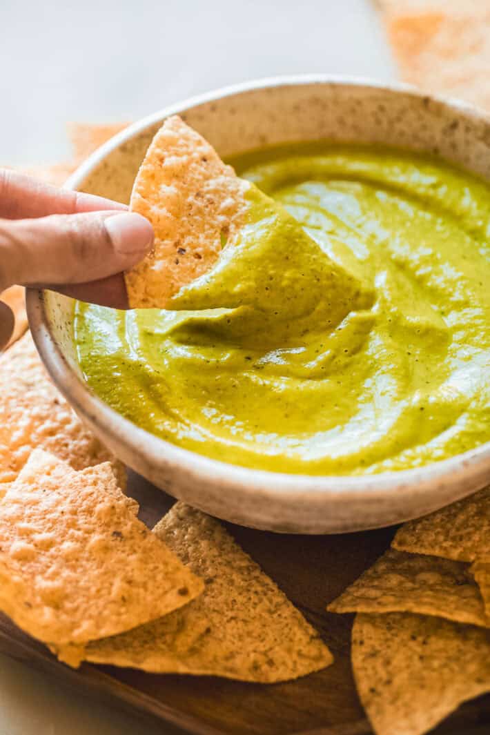 tortilla chip with green taco sauce on chip