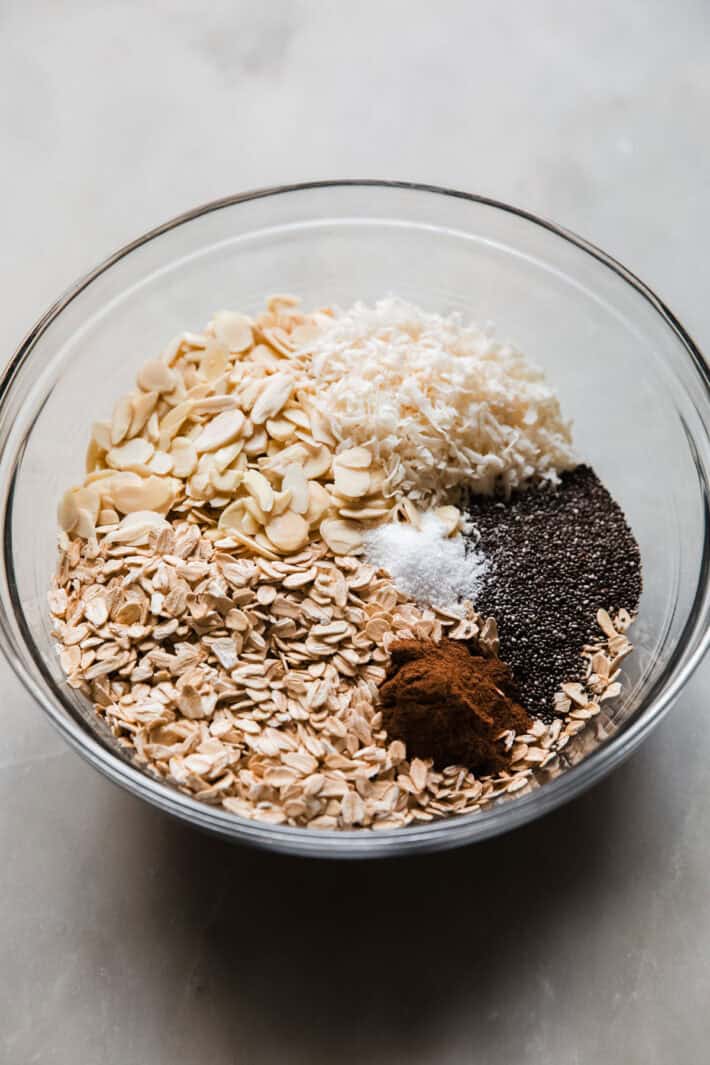 rolled oats, sliced almonds, coconut, chia seeds, cinnamon, and kosher salt in bowl to make granola