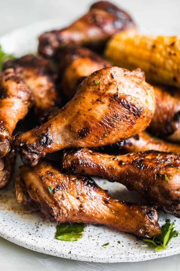 grilled drumsticks on speckled plate