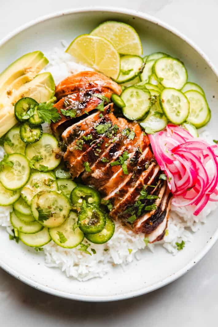 honey lime chicken over coconut rice with pickled onions, cucumbers, and avocado