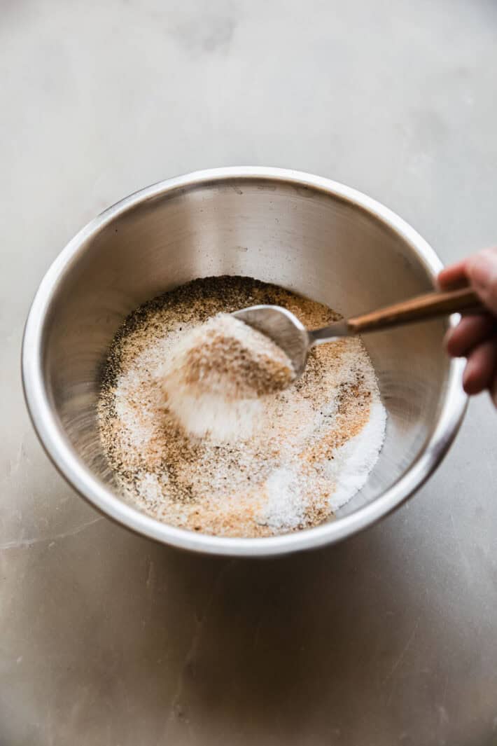 combining seasonings in a metal bowl