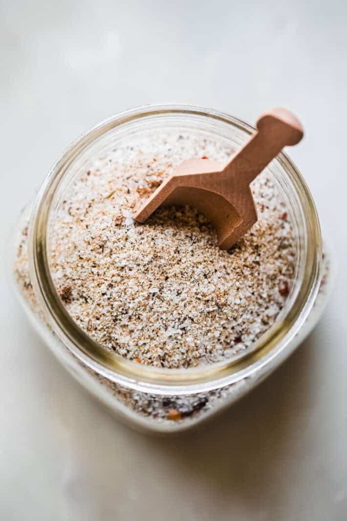 house seasoning in glass jar with wooden spoon