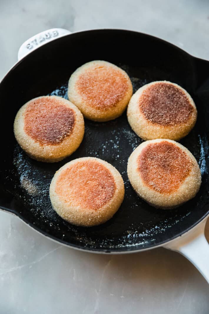 cooked English muffins in cast iron skillet