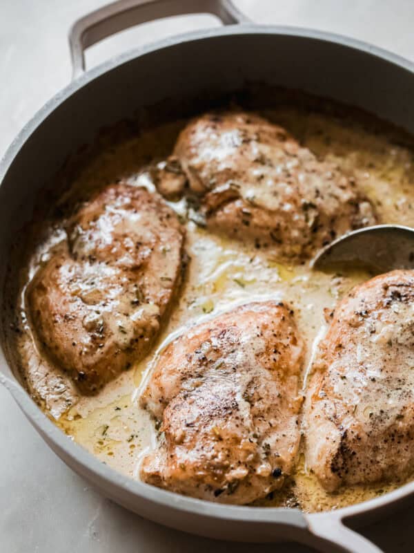 creamy peppercorn chicken in skillet with spoon