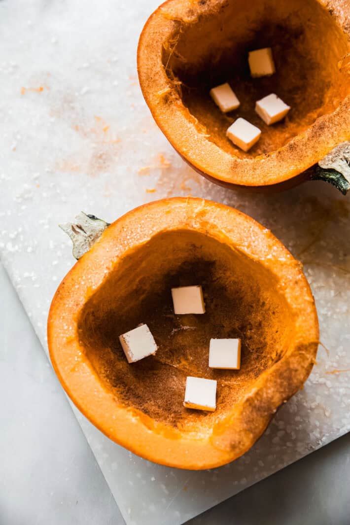 cleaned pumpkin halves with butter inside